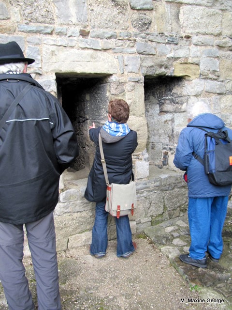  Donna Goodman, our guide explains how the soldiers used the double arrow loops at Caernarfon Castle.