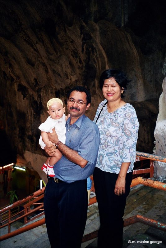 Hindu couple and baby in Hindu Temple at Malaysia's Batu Cave
